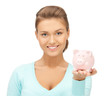 lovely woman with small piggy bank