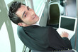 Photo: Young brown-haired man in a bus with computer Young brown-haired man in a bus with computer