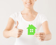 Photo: woman hands holding green house woman hands holding green house