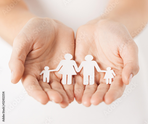 Photo: womans hands with paper man family womans hands with paper man family