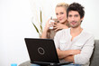 Photo: Couple relaxing at home on a Sunday morning Couple relaxing at home on a Sunday morning