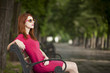 Funny hipster girl on the bench at the street