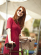 Redhead girl with bike at outdoor, city.