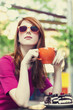 Style redhead girl with cake and cup