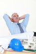 senior architect enjoying moment of relaxation in his office