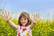 a happy little girl on a field with colza