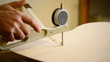 Luthier measures guitar with precision meter or gauge