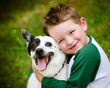 Photo: Child lovingly embraces his pet dog, a blue heeler Child lovingly embraces his pet dog, a blue heeler