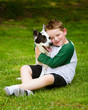 Photo: Child lovingly embraces his pet dog, a blue heeler Child lovingly embraces his pet dog, a blue heeler