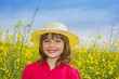 little girl on a field with colza