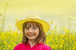 little girl on a field with  rapeseed
