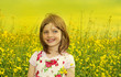 happy little girl on a rapeseed field
