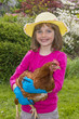 little girl with a hen