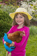 little girl holding a hen