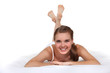 Photo: Young woman laying on bed Young woman laying on bed