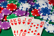 Colorful poker chips and royal flush