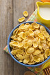 Photo: bowl of corn flakes on wood bowl of corn flakes on wood