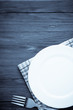 white plate and fork on wood