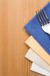 fork and knife as utensils on napkin on wood