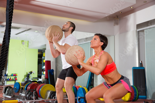 Photo: Crossfit ball fitness workout group woman and man Crossfit ball fitness workout group woman and man