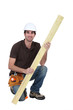 Carpenter with plank of wood