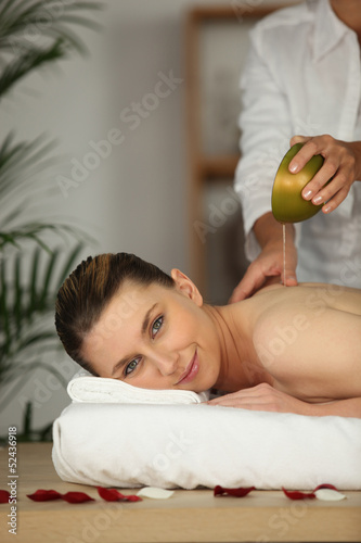 Photo: beautiful woman being massaged beautiful woman being massaged