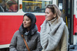 Two Young Women at Tram Stop