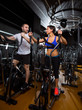 elliptical walker trainer man and woman at black gym