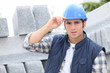 Photo: Construction worker in a hardhat next to concrete kerbing Construction worker in a hardhat next to concrete kerbing