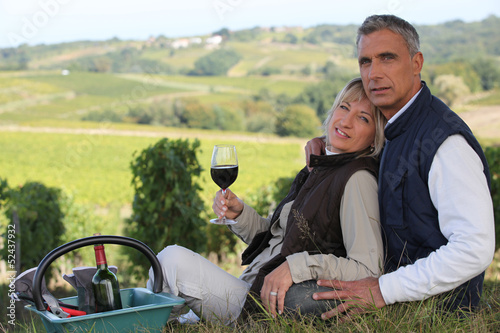Photo: Couple enjoying hill-side picnic Couple enjoying hill-side picnic