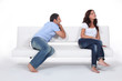 Man apolgising to woman on couch