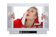 Woman with Christmas layer frame behind TV