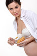 Photo: pregnant young woman eating cereals pregnant young woman eating cereals