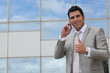 Photo: Executive using a cellphone outside Executive using a cellphone outside