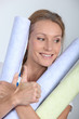 Photo: Woman holding rolls of wallpaper Woman holding rolls of wallpaper