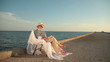 Retired woman relaxing with book at seaside