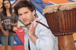 Photo: Young man carrying a djembe Young man carrying a djembe