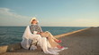 Senior woman looking to sea at sunset