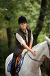 Young woman riding horse