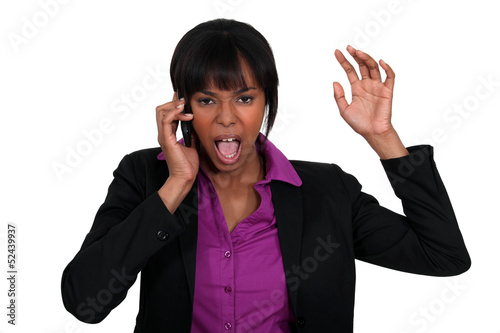Photo: Businesswoman furious over the phone. Businesswoman furious over the phone.