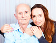 Senior man with her caregiver at home