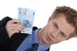 Landscape picture of young man with money