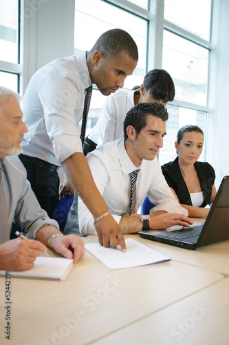 Photo: Co-workers working together on a project Co-workers working together on a project