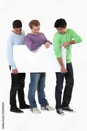 Photo: Three young lads with a blank board Three young lads with a blank board