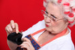 Foto: Old woman looking money in her purse Old woman looking money in her purse