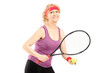 Middle aged female holding tennis racket and ball