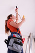 Woman measuring a wire's electrical current