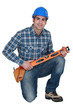 Builder knelt holding spirit level