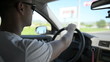 Young man driving a car. Inside shoot