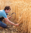 Portrait of smile harvest farmer with sickle